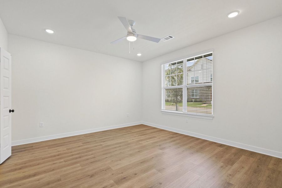 Light wood-finish flooring complements the crisp white walls
