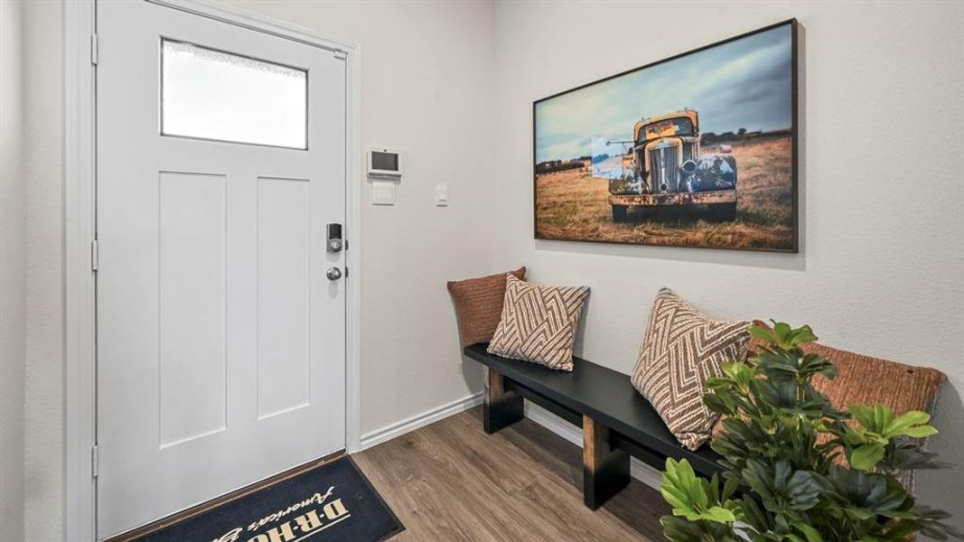 Entryway with dark wood-style flooring and baseboards