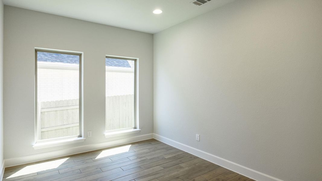 Empty room featuring baseboards, recessed lighting, and dark wood finished floors Empty room featuring baseboards, recessed lighting, and dark wood finished floors