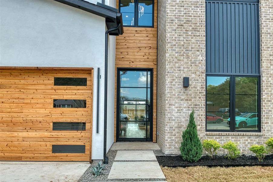 Property entrance with stucco siding and brick siding Property entrance with stucco siding and brick siding