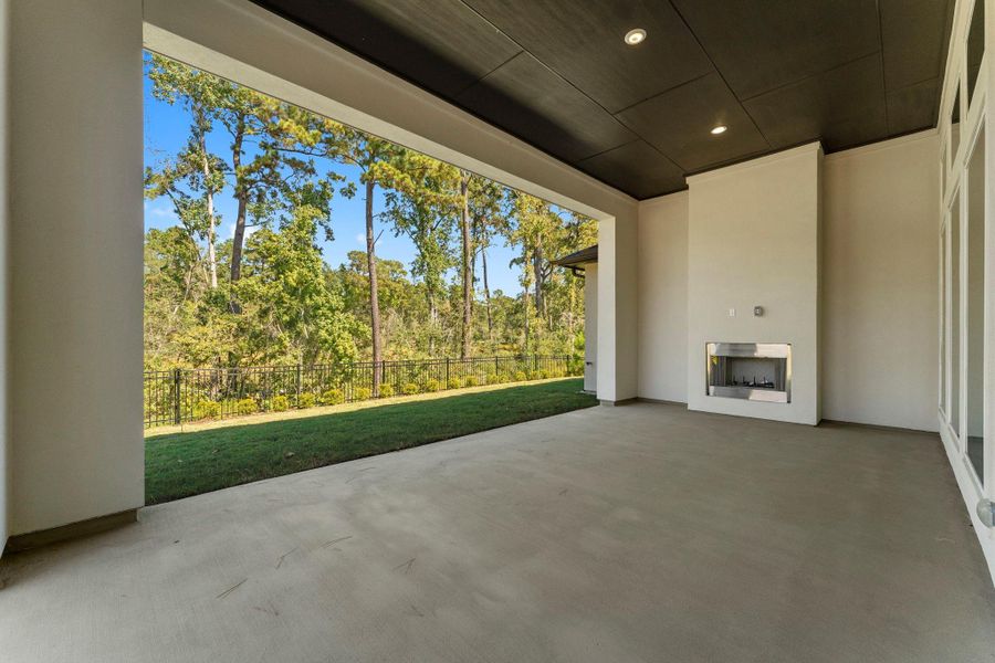 Outdoor fireplace on the covered retreat with wooded view Outdoor fireplace on the covered retreat with wooded view