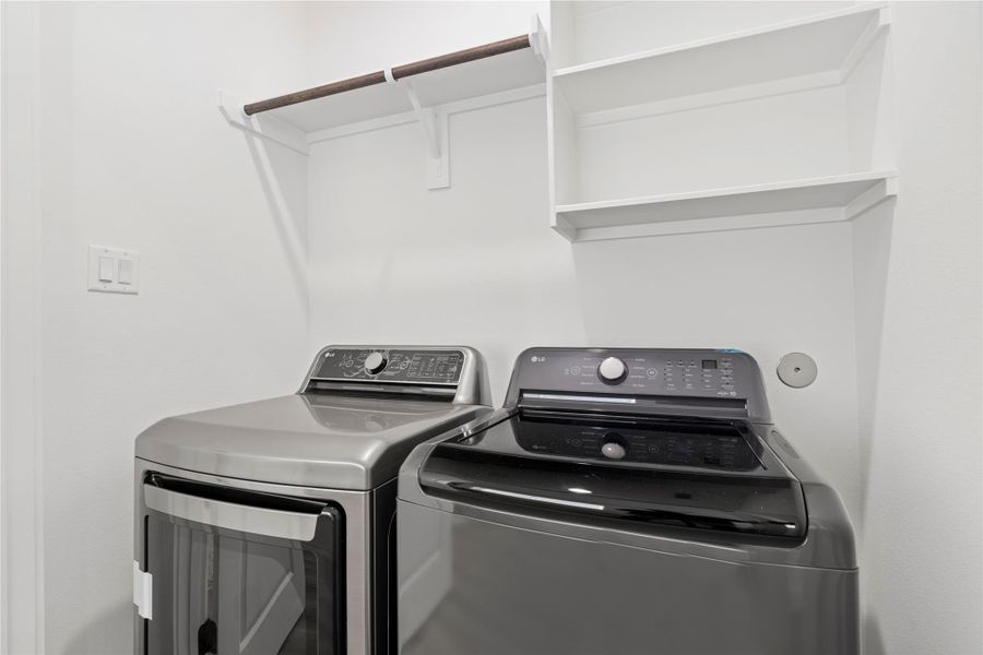 This utility room is equipped with built in shelving and a place to hang items while you work.