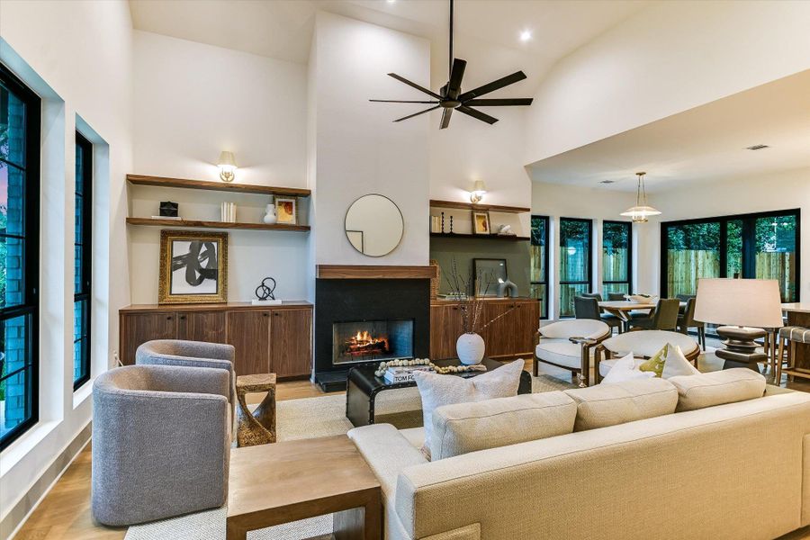 A striking fireplace is the heart of this spacious and cozy living room, framed by custom built-ins and towering ceilings. A striking fireplace is the heart of this spacious and cozy living room, framed by custom built-ins and towering ceilings.