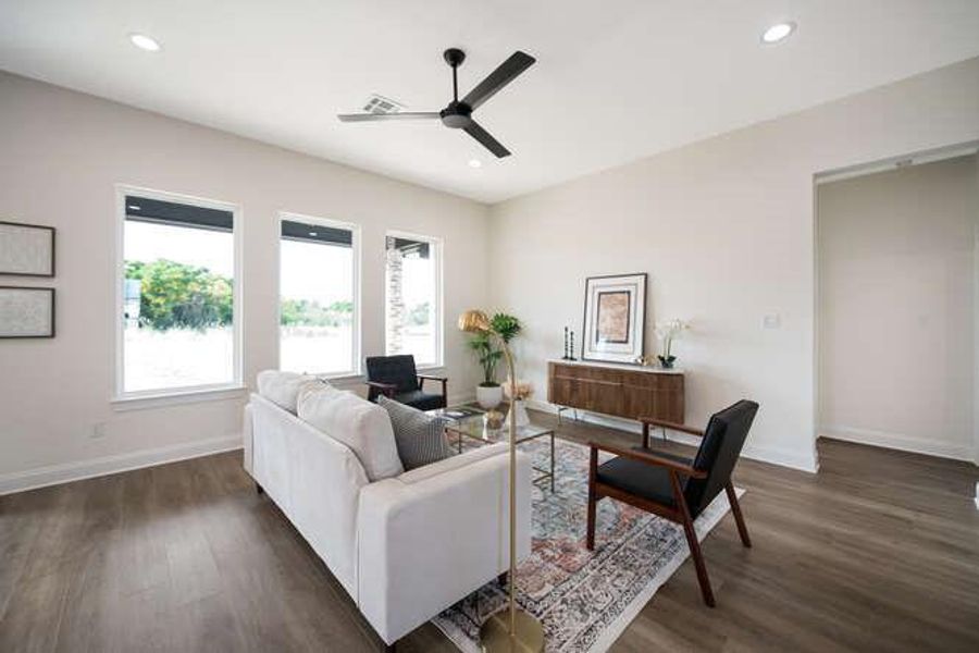Living area featuring dark wood-style floors, a ceiling fan, and recessed lighting Living area featuring dark wood-style floors, a ceiling fan, and recessed lighting