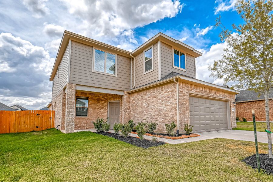Representative exterior photo of a completed home built from the Floor Plan 2340 by Colina Homes in Grand Magnolia, Magnolia, TX (Image 21). Representative exterior photo of a completed home built from the Floor Plan 2340 by Colina Homes in Grand Magnolia, Magnolia, TX (Image 21).