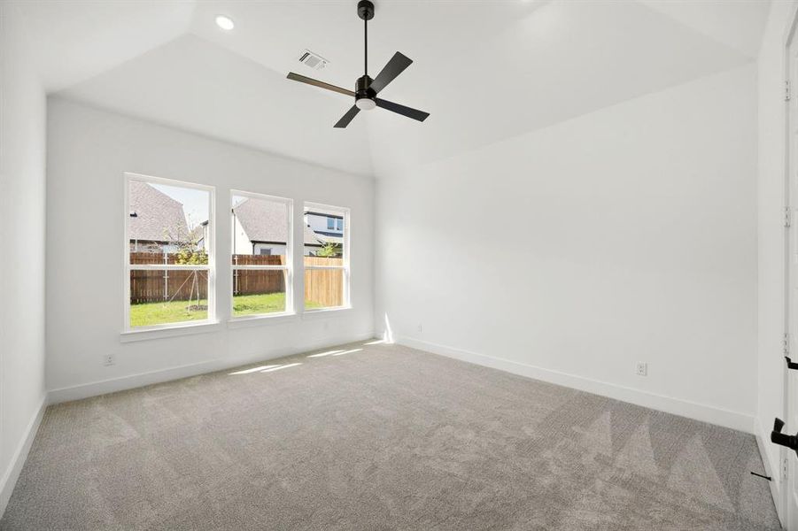 Unfurnished room with light colored carpet, lofted ceiling, ceiling fan, and recessed lighting