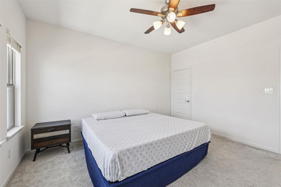 This room features light-colored walls and grey carpeting