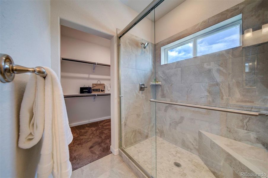 The large shower includes a seat.