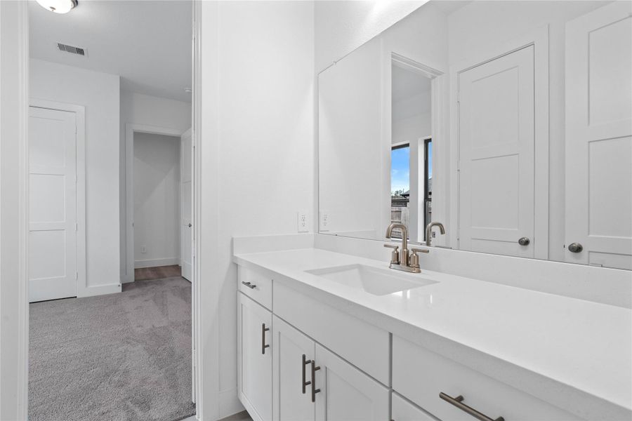 This well-appointed full bath serves two secondary bedrooms and features a convenient private entrance from one. Highlights include a versatile tub/shower combination and an expansive vanity topped with a sleek undermount sink. This well-appointed full bath serves two secondary bedrooms and features a convenient private entrance from one. Highlights include a versatile tub/shower combination and an expansive vanity topped with a sleek undermount sink.