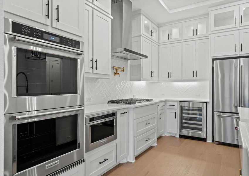 The kitchen has stainless-steel KitchenAid appliances.