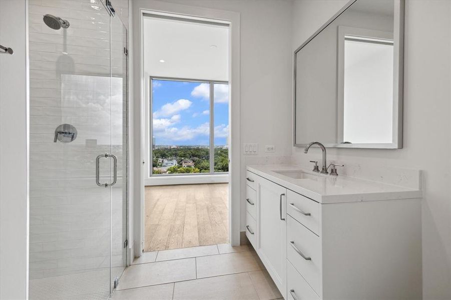 Both secondary bathrooms have zero-threshold showers with glass doors.