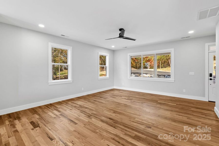 The open living area features white oak hardwood floors throughout.
