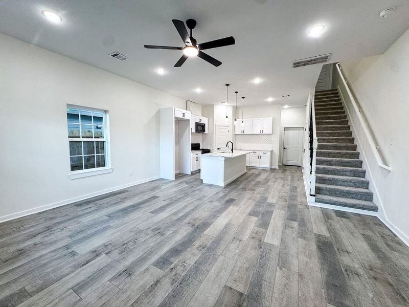 Seamlessly connected to the kitchen, this open-concept living room creates a spacious, airy flow, perfect for entertaining or everyday living. Whether hosting guests or spending time with family, the layout encourages connection and comfort. Seamlessly connected to the kitchen, this open-concept living room creates a spacious, airy flow, perfect for entertaining or everyday living. Whether hosting guests or spending time with family, the layout encourages connection and comfort.