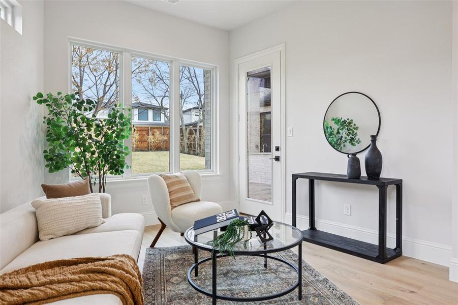 Living area with light wood-type flooring and baseboards