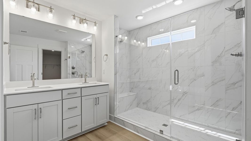 Exceptional en-suite with dual vanity and glass-enclosed walk-in shower for superior everyday comfort located at Pinebrook