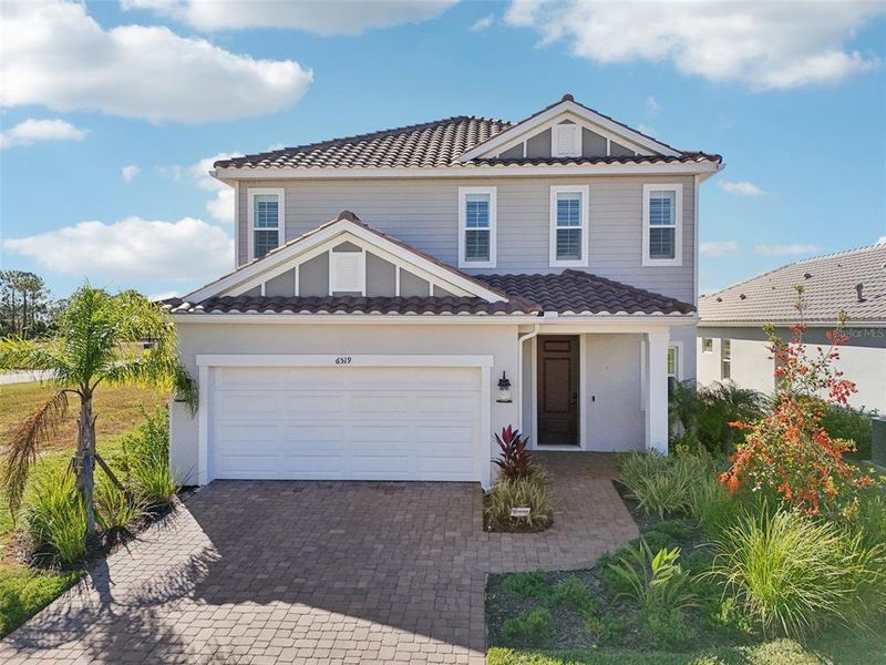 Front exterior of a new home in , Sarasota, FL, highlighting curb appeal (Image 31). Front exterior of a new home in , Sarasota, FL, highlighting curb appeal (Image 31).