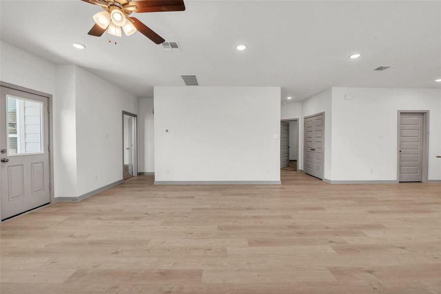 Unfurnished living room with recessed lighting, light wood-style floors, and a ceiling fan