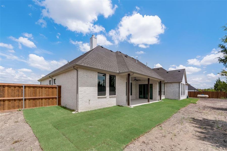 Back of property with a patio and a yard