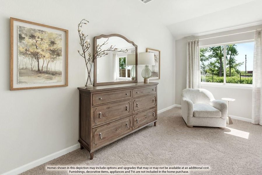 Bedroom with wood dresser, mirror, and armchair on carpet with vaulted ceiling and large window