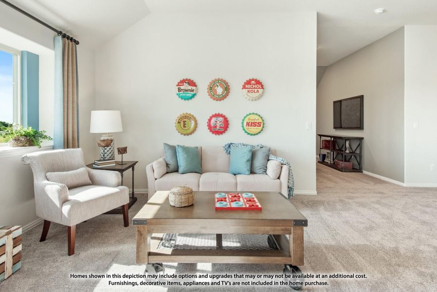 Living room with gray sofa, accent chair, wood coffee table, and colorful bottle cap wall art on white walls