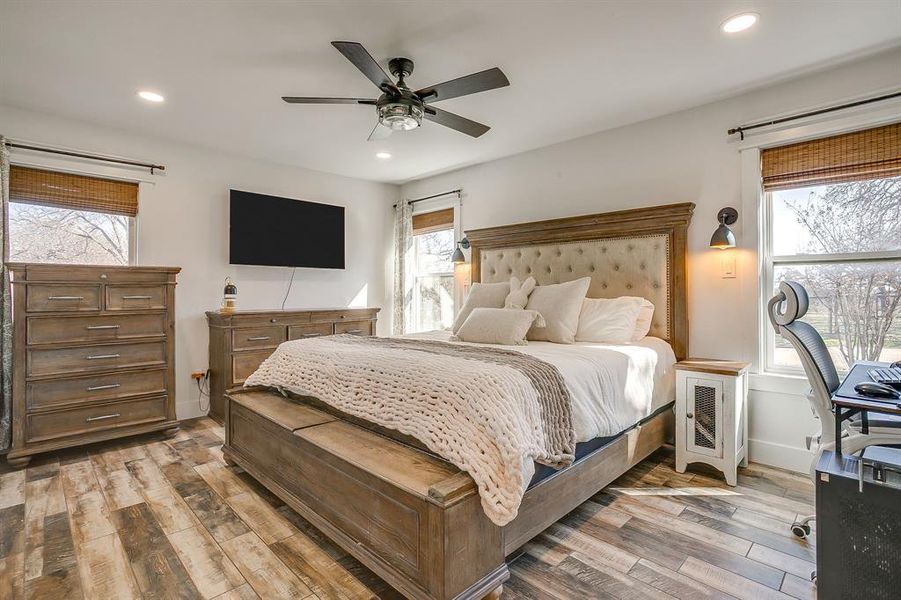 Bedroom featuring light wood-style flooring, ceiling fan, recessed lighting, and radiator