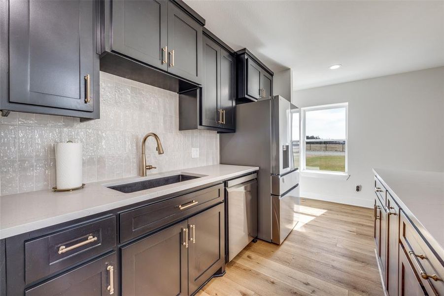 Beautiful custom cabinetry and decorative ceramic tile backsplash