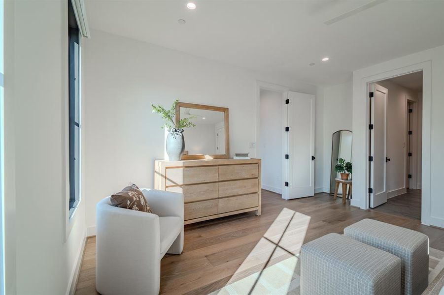 Living area with recessed lighting and wood finished floors Living area with recessed lighting and wood finished floors