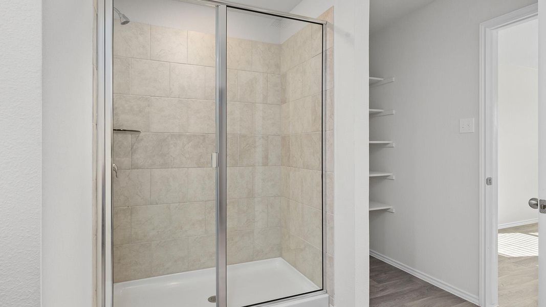 Full bathroom with a shower stall and light wood-style flooring