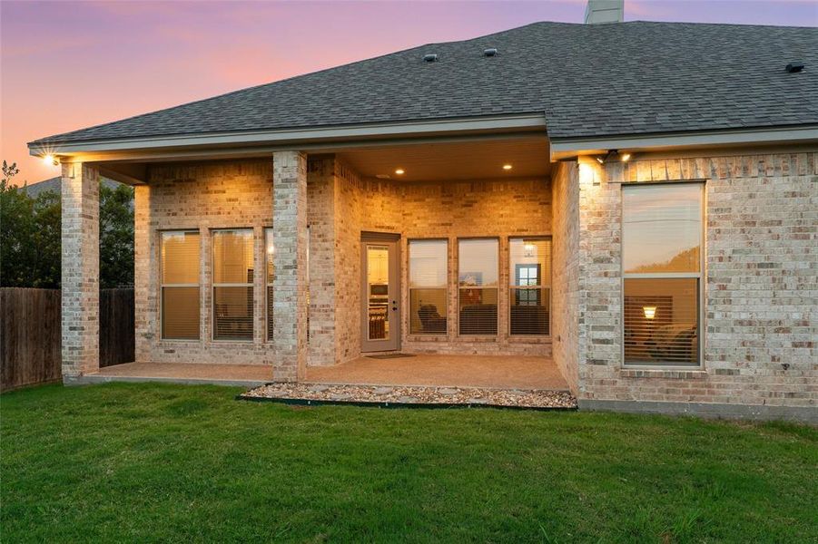 Expansive covered rear patio with brick columns and recessed lighting, spanning the back of the main living areas. Expansive covered rear patio with brick columns and recessed lighting, spanning the back of the main living areas.