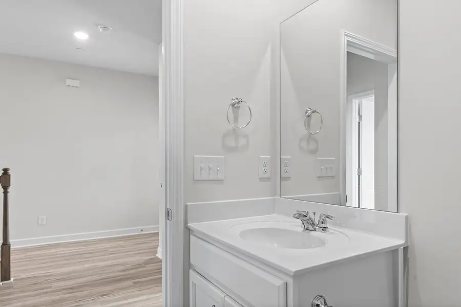 A bathroom with a large mirror. A bathroom with a large mirror.