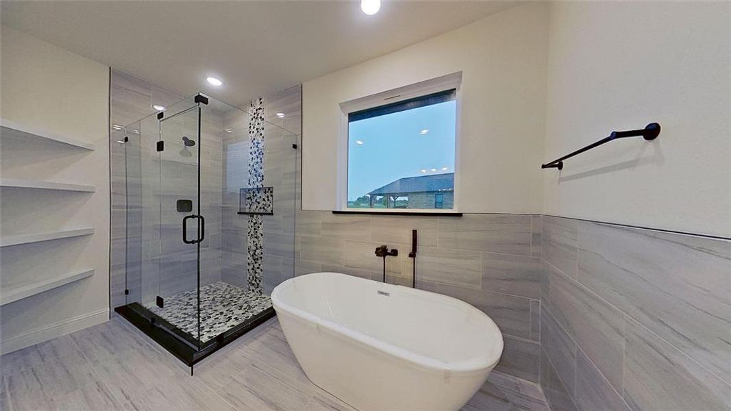 Full bathroom with double vanity, a shower stall, and light wood-style floors Full bathroom with double vanity, a shower stall, and light wood-style floors