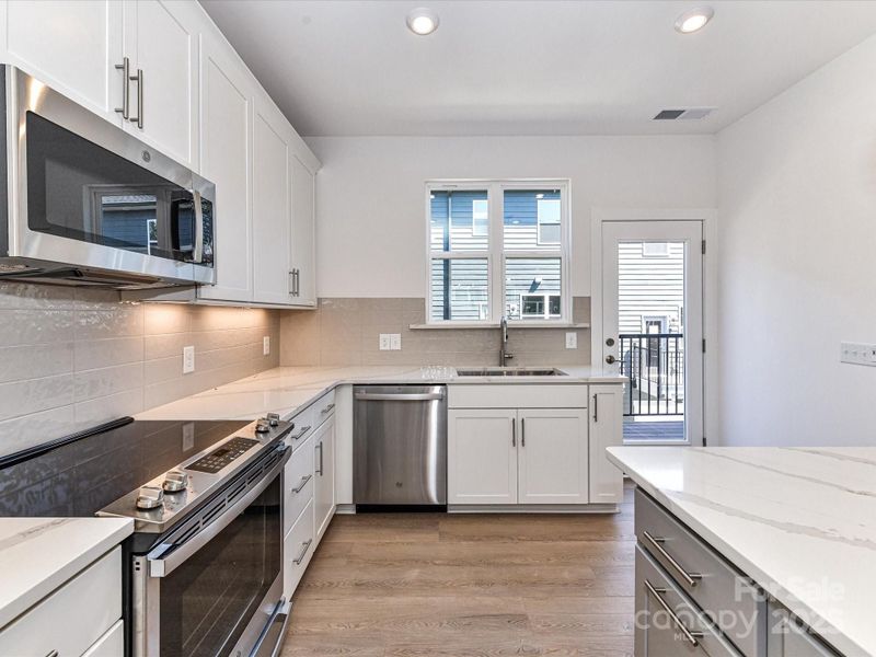 Large Kitchen with Sink Underneath Bright Window
