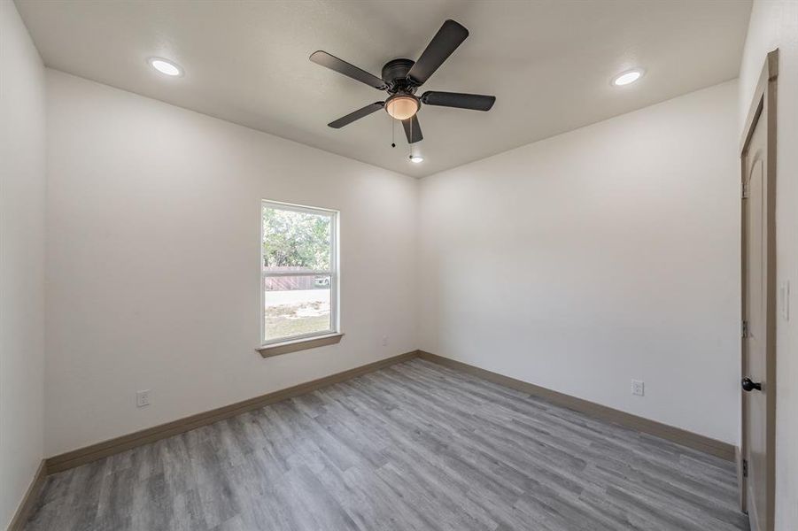 Empty room featuring light wood-type flooring, recessed lighting, and ceiling fan
