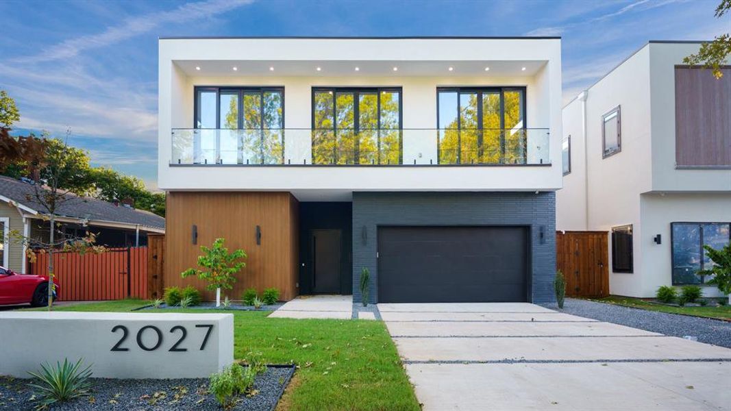 Modern home with a garage and a balcony