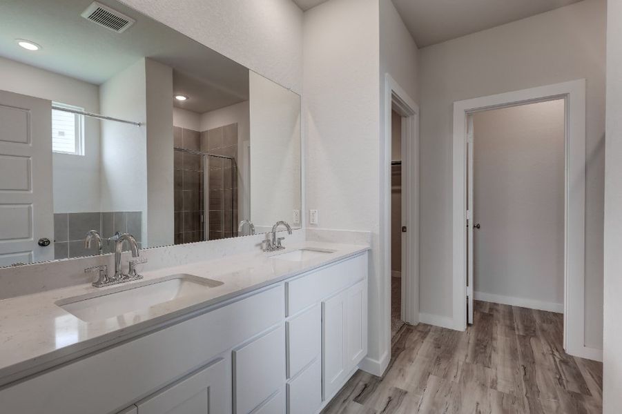 A bathroom with a large mirror. A bathroom with a large mirror.