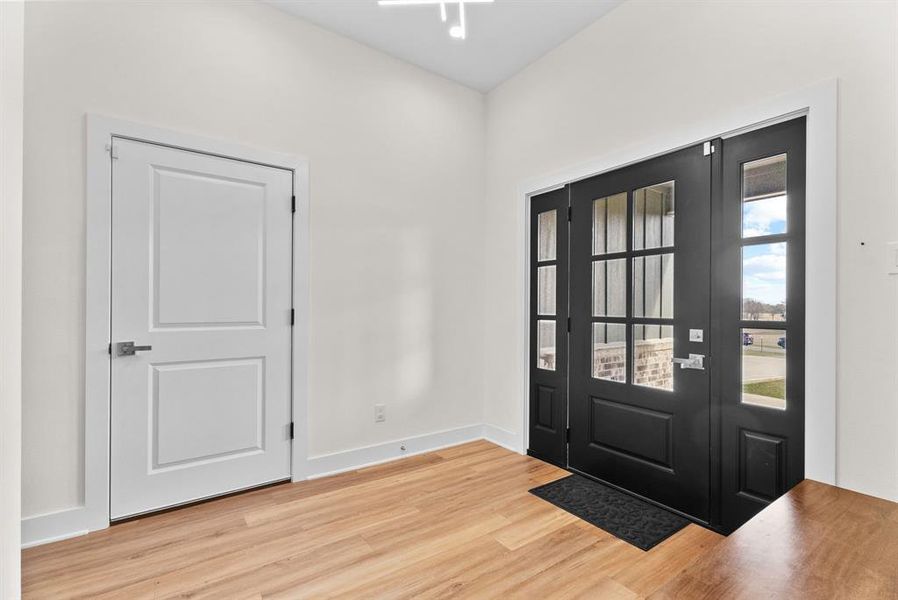 Entrance foyer featuring wood finished floors and baseboards
