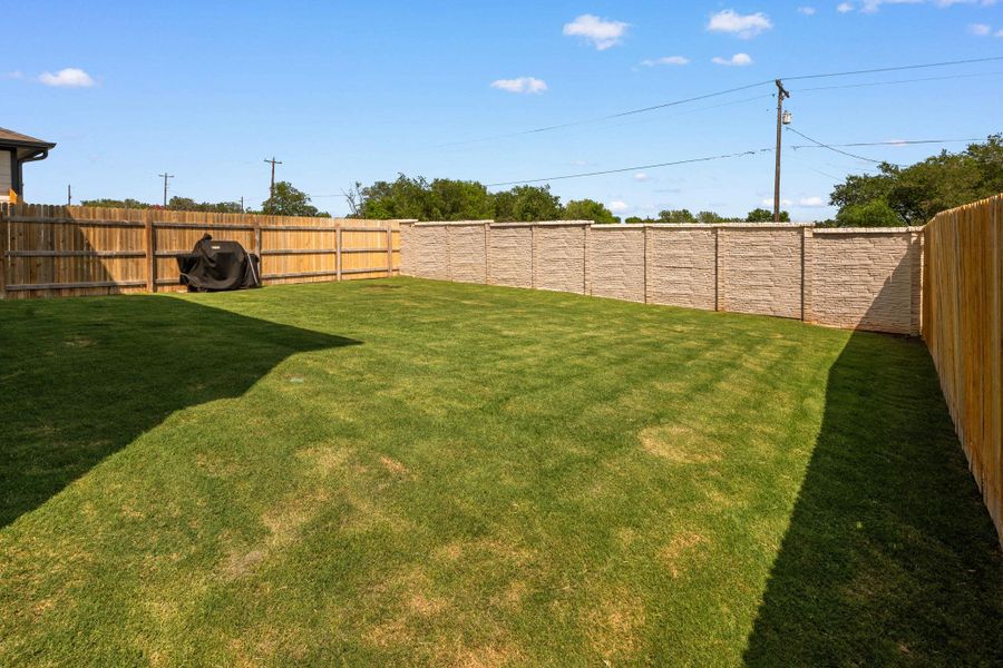 A well-maintained lawn provides a private outdoor retreat with sturdy fencing. Light colored wall maintained by HOA. A well-maintained lawn provides a private outdoor retreat with sturdy fencing. Light colored wall maintained by HOA.