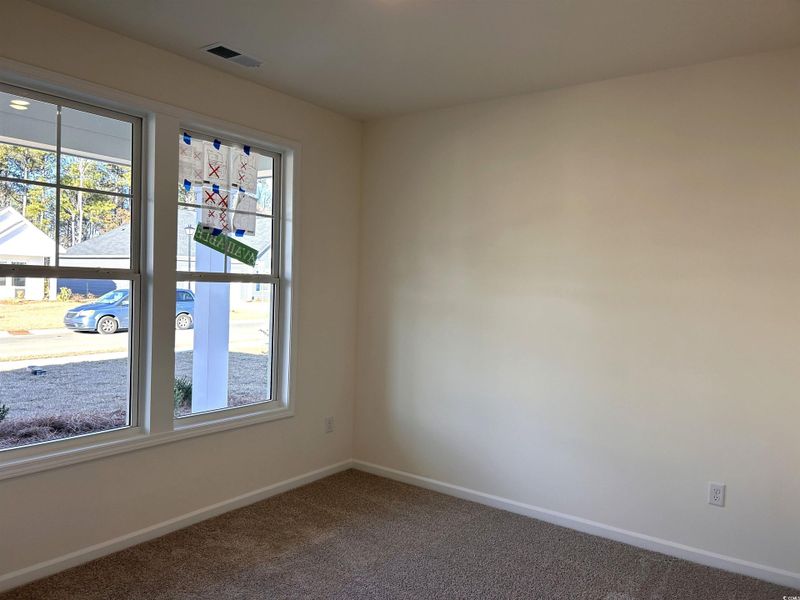 Empty room featuring baseboards and carpet flooring