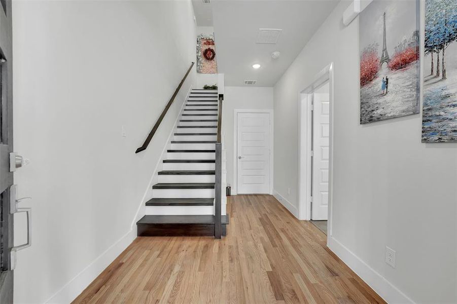 Stairway with hardwood / wood-style flooring