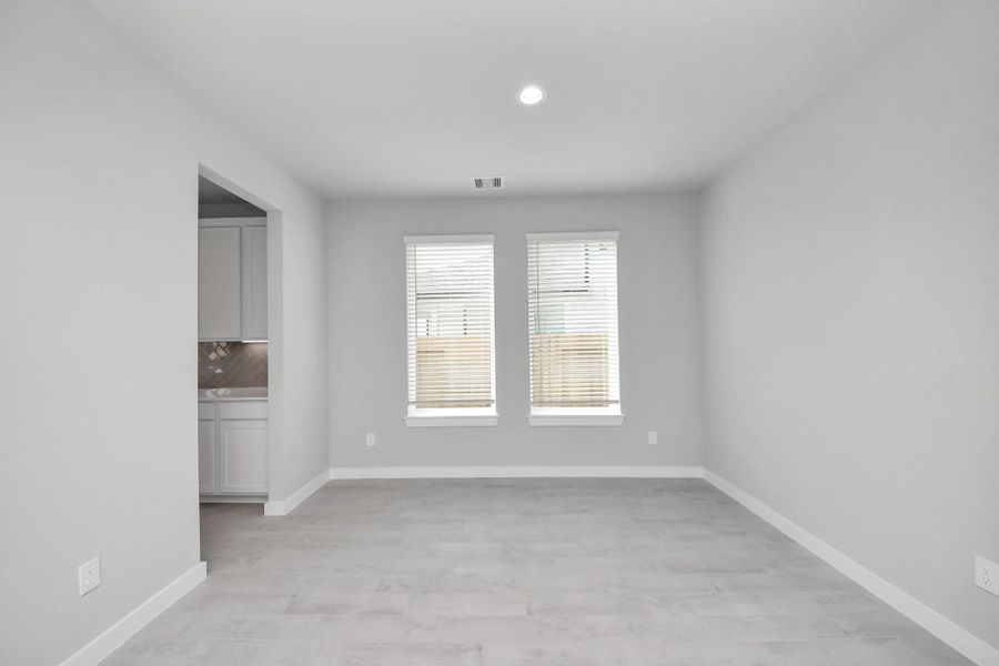 Create lasting memories with your family and friends at the dining table! This expansive dining room showcases sophisticated flooring, custom paint, and seamlessly connects to the family room and kitchen, providing an open and inviting atmosphere. Sample photo of completed home with similar floor plan. Actual colors and selections may vary. Create lasting memories with your family and friends at the dining table! This expansive dining room showcases sophisticated flooring, custom paint, and seamlessly connects to the family room and kitchen, providing an open and inviting atmosphere. Sample photo of completed home with similar floor plan. Actual colors and selections may vary.