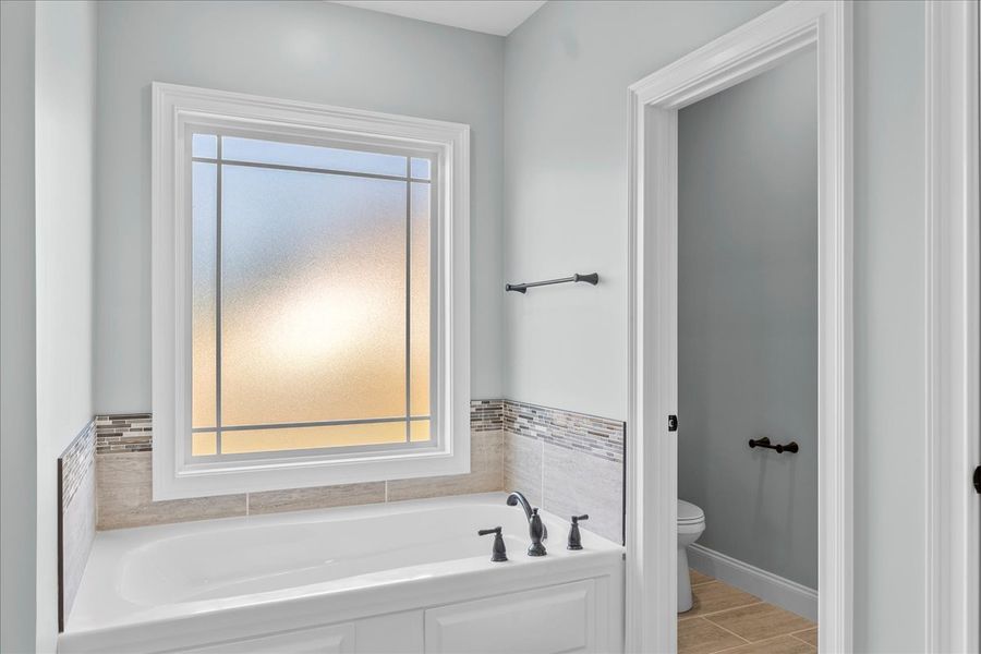 Representative furnished interior of a home built from the Converse Elite by Enchanted Homes in Pointe Summit, Slater-Marietta (Image 42).