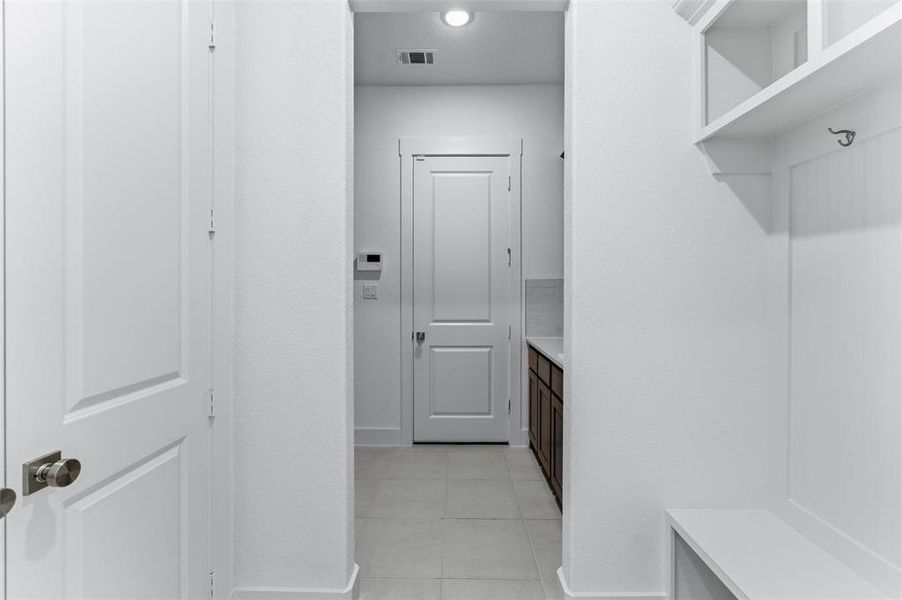 Mudroom featuring baseboards and light tile patterned floors