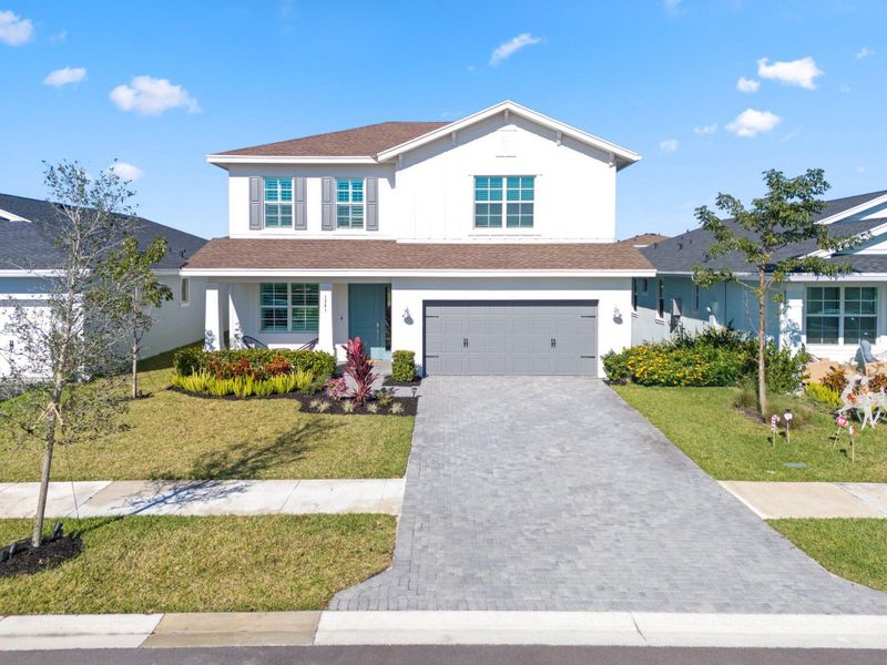 Front exterior of a new home in , Loxahatchee, FL, highlighting curb appeal (Image 24).