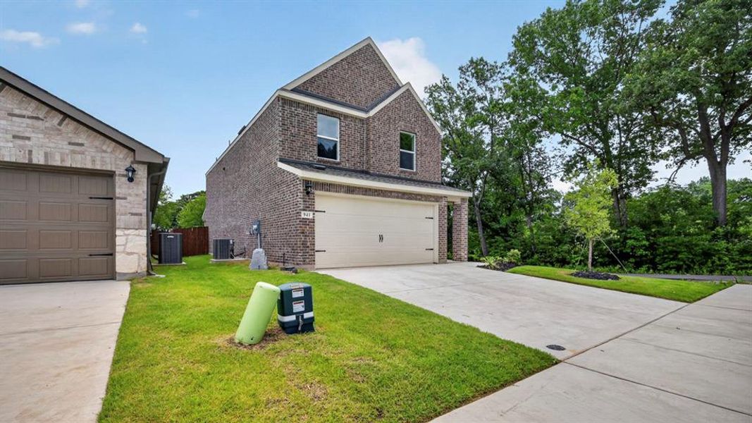 Front exterior of a new home in Hanolley Hills, Sherman, TX, highlighting curb appeal (Image 2). Front exterior of a new home in Hanolley Hills, Sherman, TX, highlighting curb appeal (Image 2).