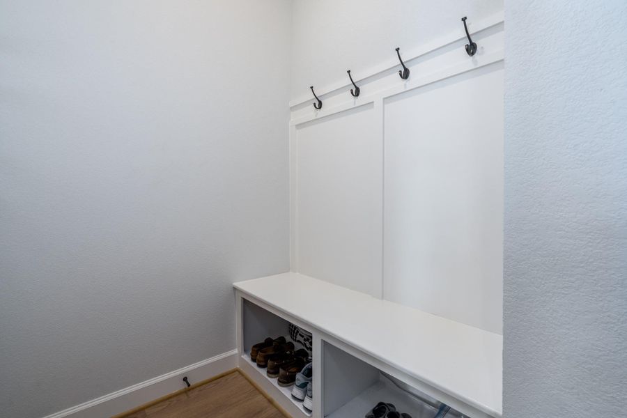 Mud room off of the garage entry with storage, bench seating and four coat/backpack hooks. Mud room off of the garage entry with storage, bench seating and four coat/backpack hooks.