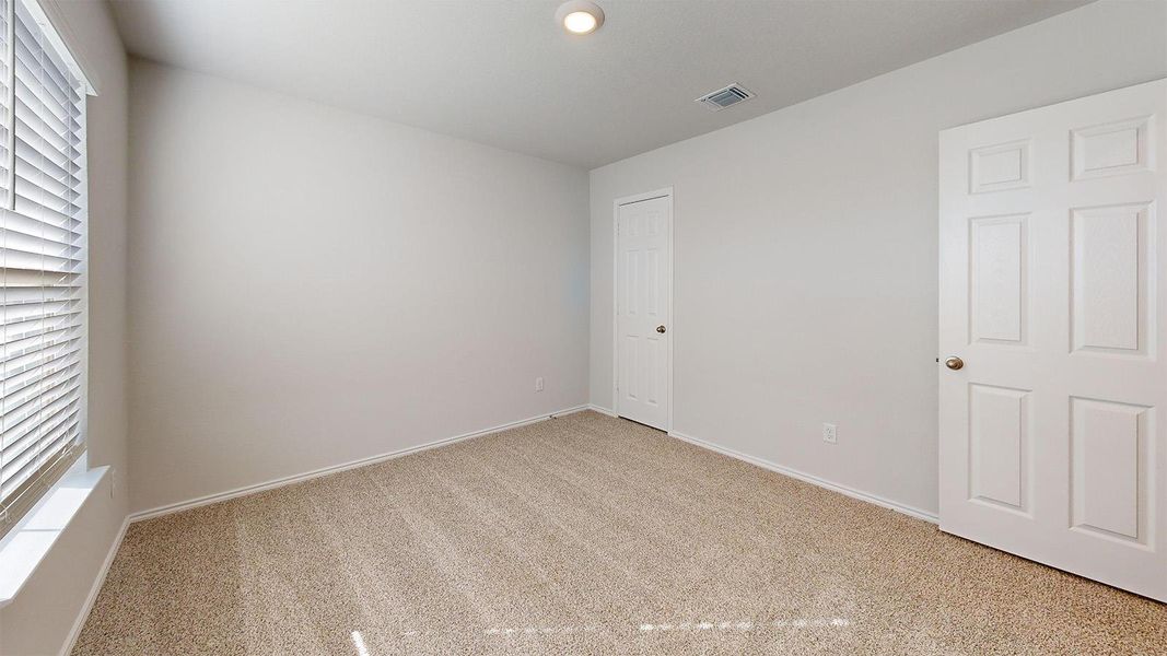 Unfurnished bedroom featuring light carpet and recessed lighting