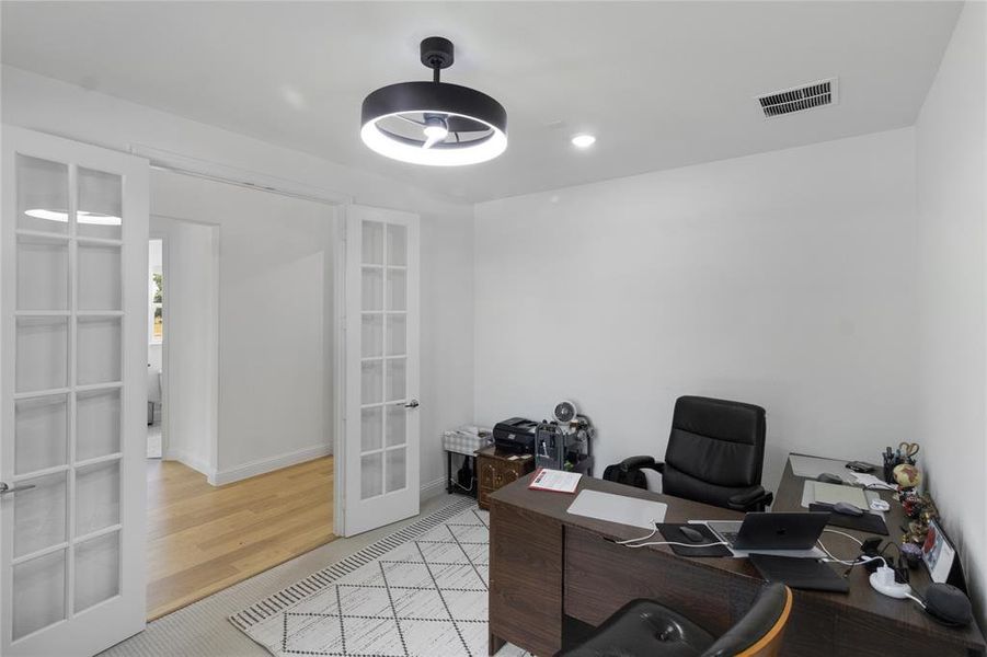 Room featuring double French doors, recessed lighting, and a modern ceiling light fixture
