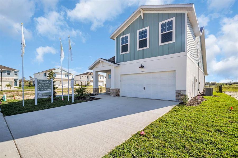 Front exterior of a new home in Emerald Fields, Hudson, FL, highlighting curb appeal (Image 25).