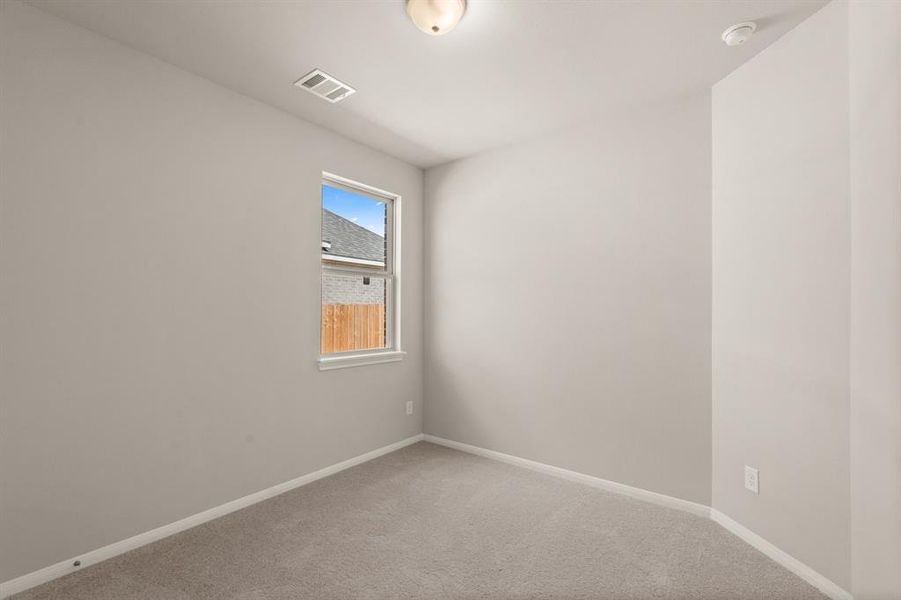 Your secondary bedroom features plush carpet, fresh paint, closet, and a large window that lets in plenty of natural lighting.