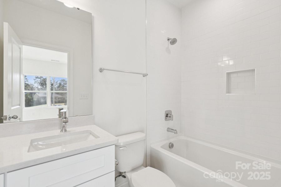 Large primary bedroom with huge walk-in closet and en-suite bathroom complete with a tiled shower wall Large primary bedroom with huge walk-in closet and en-suite bathroom complete with a tiled shower wall